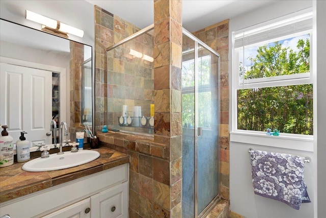 bathroom with vanity and a shower stall