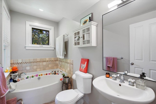 bathroom with a bath, toilet, and a sink