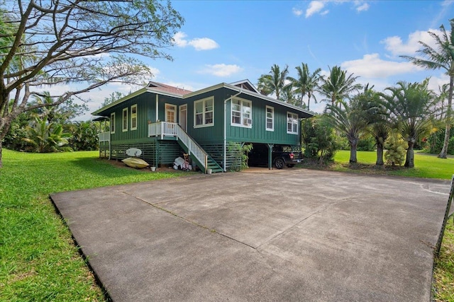 exterior space featuring a yard, stairs, and driveway