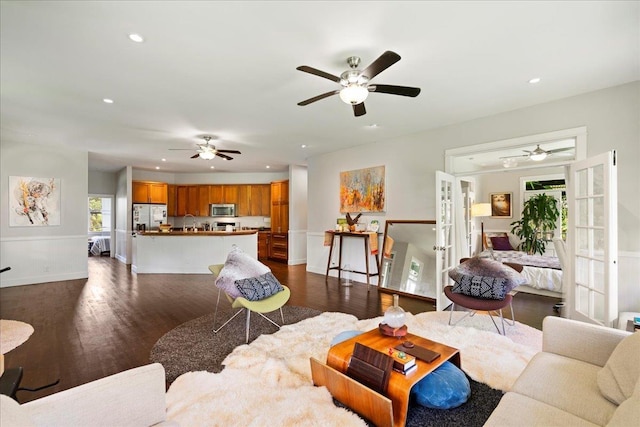 living room featuring dark wood finished floors, ceiling fan, and recessed lighting