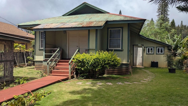 rear view of house with a yard and fence