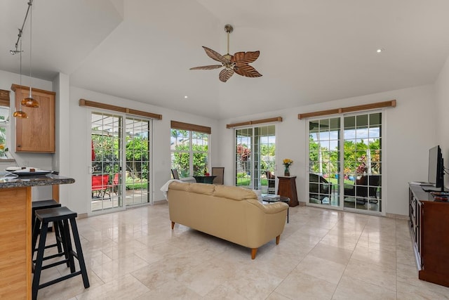 living room featuring vaulted ceiling and ceiling fan