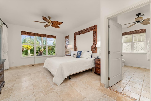 bedroom featuring ceiling fan and ensuite bath