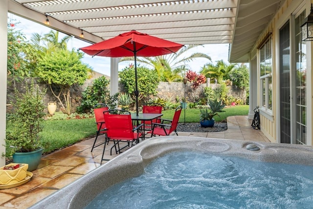 view of patio / terrace with a hot tub and a pergola