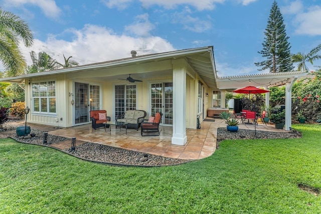 rear view of property featuring a patio, a lawn, ceiling fan, and a pergola