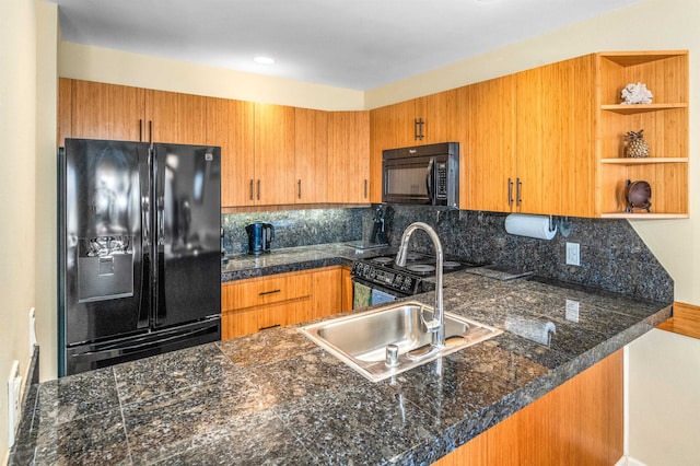 kitchen featuring black appliances, decorative backsplash, kitchen peninsula, and sink