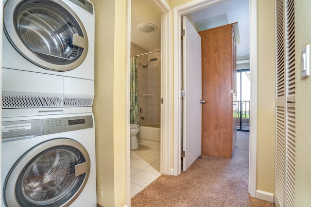 washroom with stacked washer / drying machine and light colored carpet