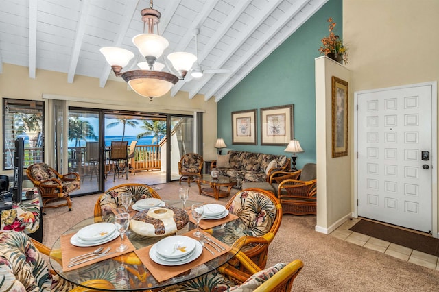 dining area featuring beam ceiling, tile patterned flooring, high vaulted ceiling, wood ceiling, and ceiling fan with notable chandelier