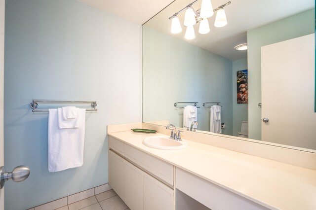 bathroom featuring tile patterned floors, vanity, and toilet