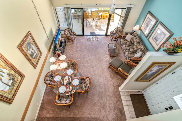 tiled living room featuring a high ceiling and a chandelier