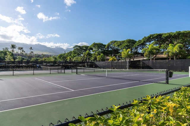 view of tennis court featuring a mountain view