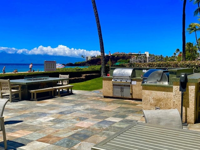 view of patio / terrace featuring a water view and area for grilling