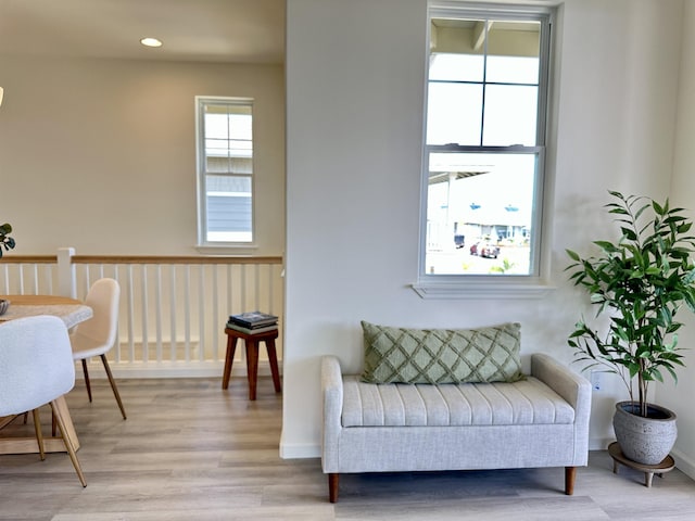 living area with recessed lighting, light wood-style flooring, and baseboards