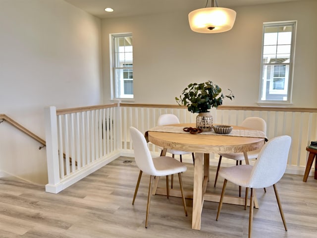 dining space with light wood finished floors and recessed lighting