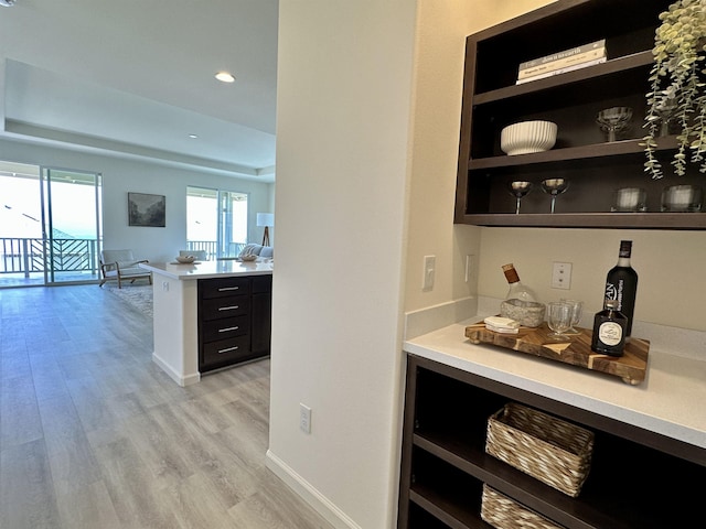 bar with recessed lighting, a dry bar, light wood-style flooring, and baseboards