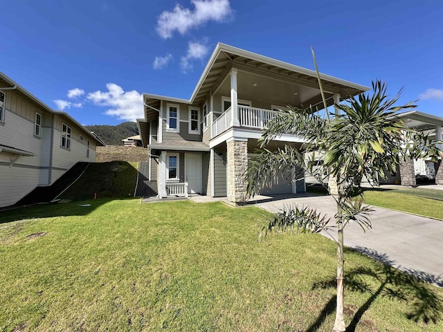 view of front of home featuring a balcony, a carport, concrete driveway, and a front yard