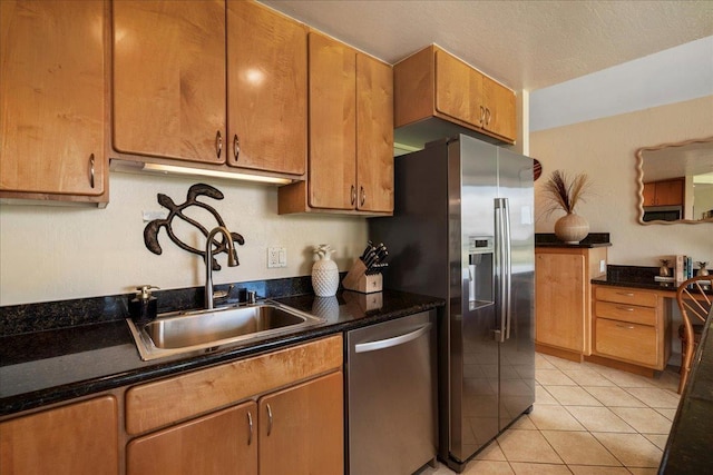 2936 S Kihei Rd Unit 213, Kihei, HI 96753 - kitchen featuring stainless steel appliances, a sink, light tile patterned floors, and brown cabinetry