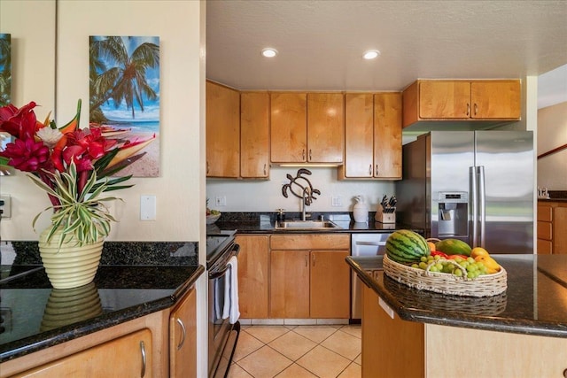 2936 S Kihei Rd Unit 213, Kihei, HI 96753 - kitchen featuring stainless steel appliances, a sink, light tile patterned floors, recessed lighting, and dark stone counters