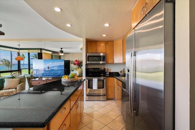 2936 S Kihei Rd Unit 213, Kihei, HI 96753 - kitchen featuring appliances with stainless steel finishes, recessed lighting, light tile patterned floors, brown cabinets, and a textured ceiling