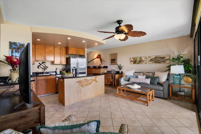 2936 S Kihei Rd Unit 213, Kihei, HI 96753 - kitchen featuring stainless steel fridge with ice dispenser, dark countertops, open floor plan, a center island, and a ceiling fan