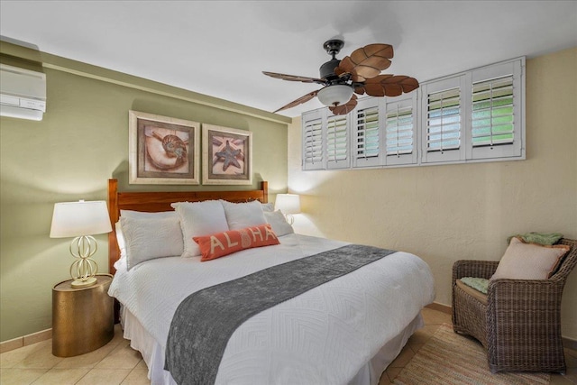 2936 S Kihei Rd Unit 213, Kihei, HI 96753 - tiled bedroom featuring a wall unit AC, baseboards, and ceiling fan