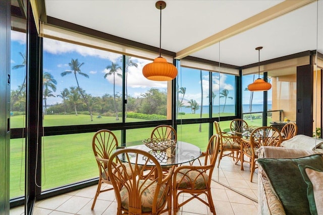 2936 S Kihei Rd Unit 213, Kihei, HI 96753 - sunroom featuring tile patterned flooring, a wall of windows, outdoor dining area, and a water view