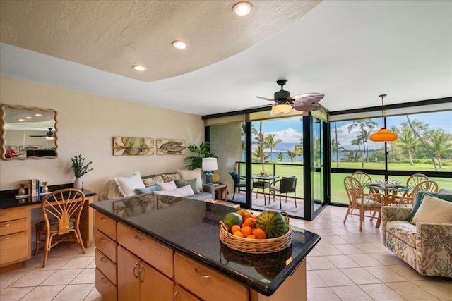 2936 S Kihei Rd Unit 213, Kihei, HI 96753 - kitchen with light tile patterned floors, open floor plan, expansive windows, an office area, and ceiling fan