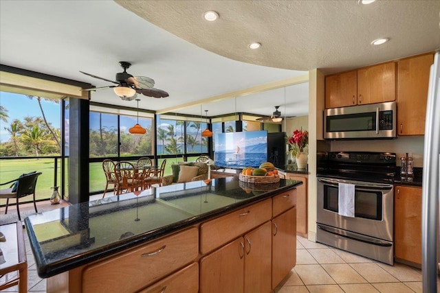 2936 S Kihei Rd Unit 213, Kihei, HI 96753 - kitchen with appliances with stainless steel finishes, ceiling fan, light tile patterned flooring, a textured ceiling, and brown cabinetry