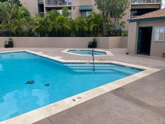 view of pool with a community hot tub and a patio