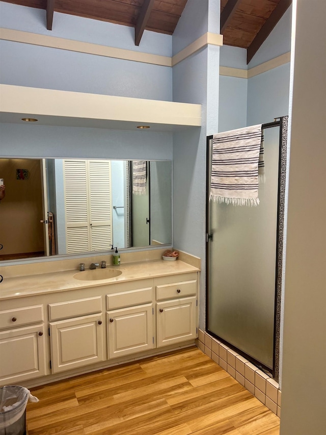 bathroom with hardwood / wood-style flooring, lofted ceiling with beams, wood ceiling, and vanity