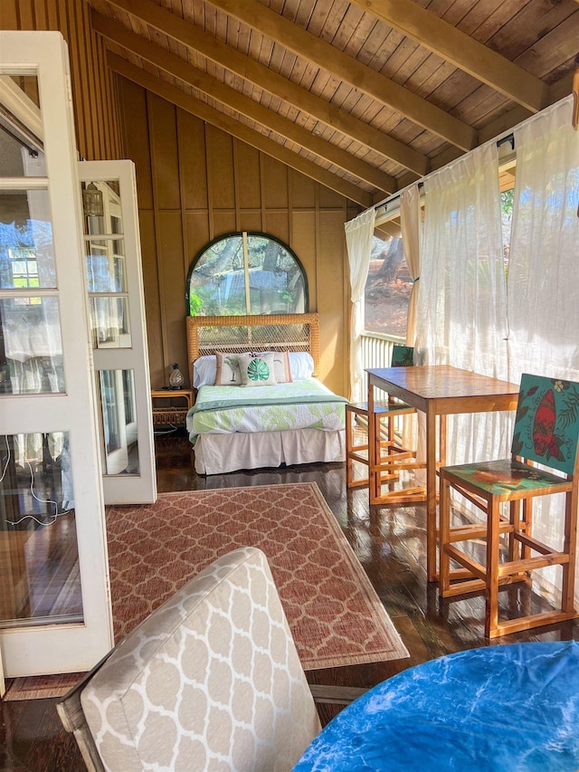 interior space featuring vaulted ceiling with beams and wooden ceiling