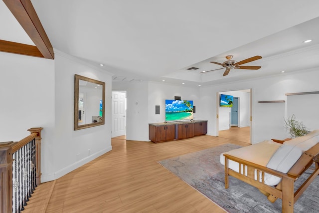 living room featuring ceiling fan, light hardwood / wood-style floors, and ornamental molding