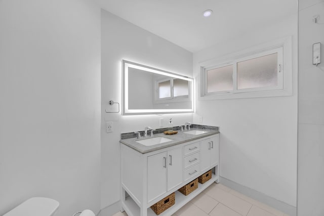 bathroom with tile patterned floors, vanity, and toilet