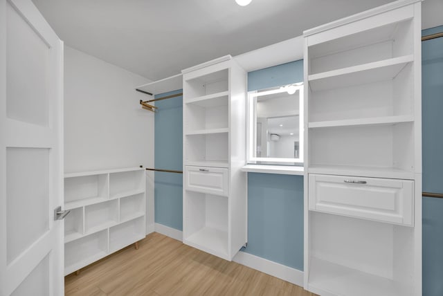 spacious closet with light hardwood / wood-style floors