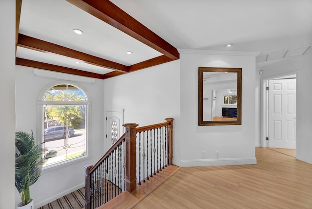 hallway featuring beamed ceiling and light hardwood / wood-style floors