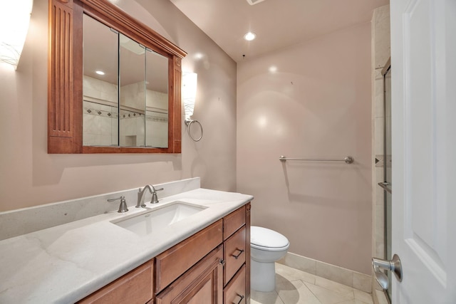 bathroom featuring tile patterned flooring, vanity, and toilet