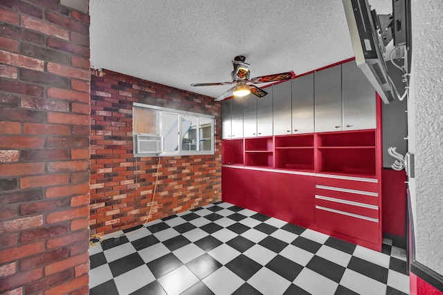 interior space featuring a textured ceiling, ceiling fan, cooling unit, and brick wall