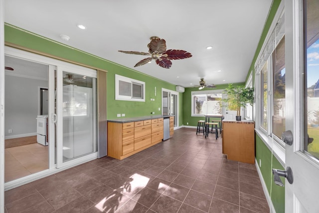 sunroom featuring ceiling fan