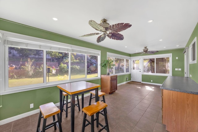 sunroom / solarium featuring ceiling fan