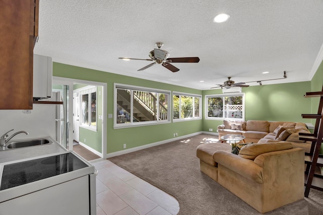 living room featuring a textured ceiling, light colored carpet, and sink