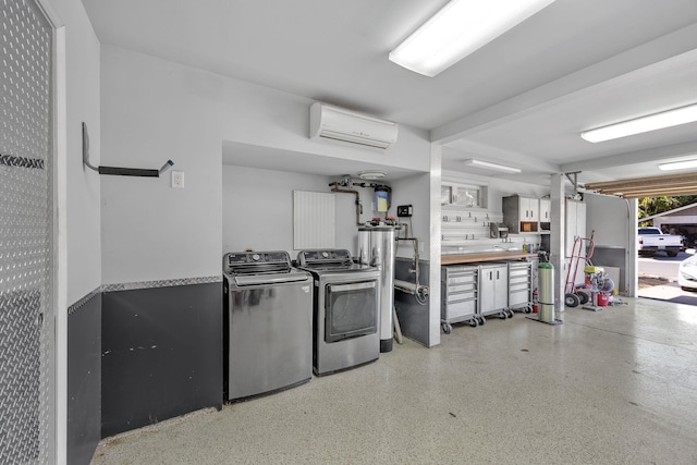 clothes washing area featuring washing machine and dryer and a wall unit AC