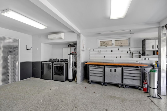 interior space with a wall mounted AC, water heater, and washer and dryer