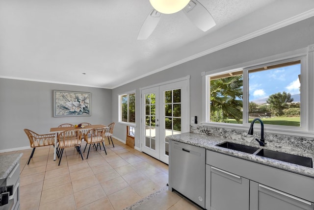 tiled dining space with ceiling fan, crown molding, sink, and french doors