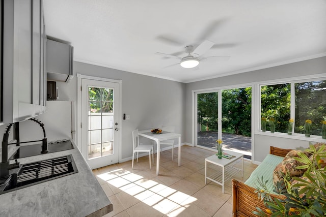 kitchen with light tile patterned floors, gray cabinets, ceiling fan, and ornamental molding