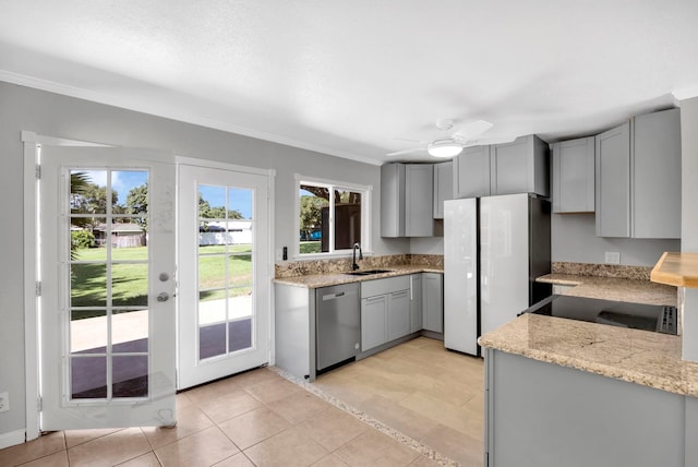 kitchen with white refrigerator, gray cabinets, stainless steel dishwasher, and ceiling fan