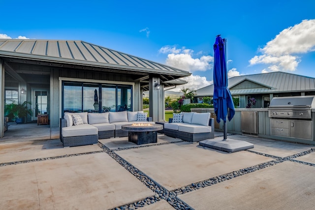 view of patio featuring an outdoor kitchen, area for grilling, and an outdoor living space with a fire pit