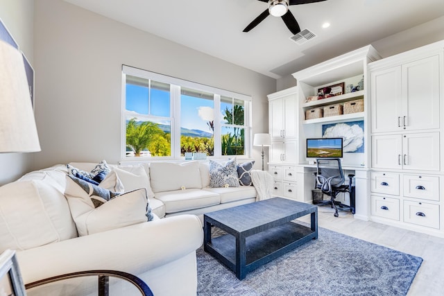 living room featuring ceiling fan and light hardwood / wood-style floors