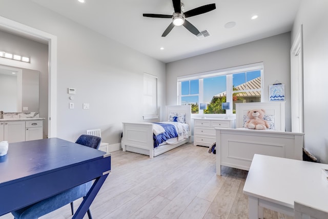 bedroom with light wood-type flooring, ensuite bathroom, and ceiling fan