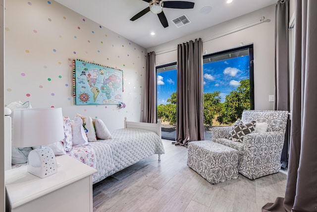 bedroom with hardwood / wood-style floors, ceiling fan, and access to exterior