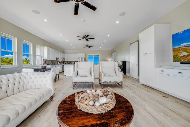 living room featuring light wood-type flooring and ceiling fan